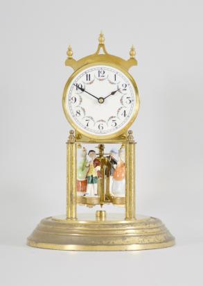 Forestville Clock Co., Germany, 400-day clock, year running, spring driven brass movement with torsion pendulum, brass base and posts holding movement, arabic numeral arcaded white enamel dial, black steel spade hands, and pendulum with ceramic dancing figures, all under a glass dome. 










