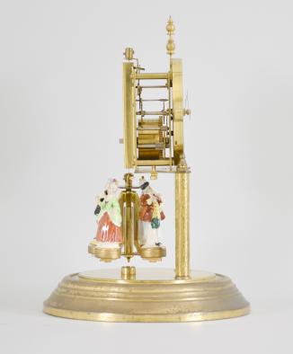 Forestville Clock Co., Germany, 400-day clock, year running, spring driven brass movement with torsion pendulum, brass base and posts holding movement, arabic numeral arcaded white enamel dial, black steel spade hands, and pendulum with ceramic dancing figures, all under a glass dome. 










