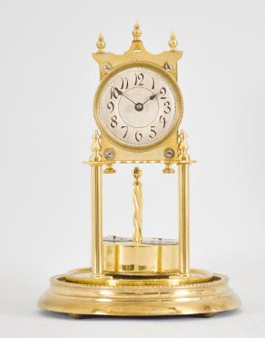 W. Würth & Co., Schwenningen, Germany, 400-day clock, year running, time only, spring driven brass movement with torsion pendulum, brass base and posts, arabic numeral silvered dial with black steel spade hands, rare two-dial Würth pendulum.
