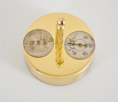 W. Würth & Co., Schwenningen, Germany, 400-day clock, year running, time only, spring driven brass movement with torsion pendulum, brass base and posts, arabic numeral silvered dial with black steel spade hands, rare two-dial Würth pendulum.
