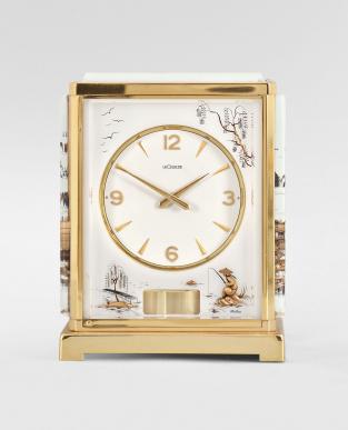 Jaeger-LeCoultre, Switzerland, Atmos "Marina" model, 526-5 caliber jeweled movement with torsion pendulum, in a gilt case with frosted acrylic panels having gold Asian motifs, signed round white dial, gilt arabic numerals, and gold hands over a rectangular pendulum aperture.