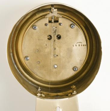 Urania / Kienzle GmbH, Schwenningen, Germany, hanging 400-day banjo clock, year running, front-wound spring driven movement with torsion pendulum in polished brass case with beveled glasses, arabic numeral silvered metal dial, and black steel hands.