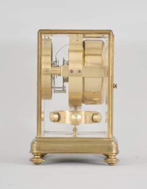 Jean Leon Reutter / Jaeger LeCoultre, an early model K2 shelf or mantel clock, the gilt brass case with molded base on turned feet, and ovolo molded frame set with five bevelled glasses, roman numeral white enamel dial signed "Atmos Pendule Perpetuelle" below 12:00, and " Brevets J. L. Reutter Made in France" below 6:00, blued steel Breguet style hands, 16 jewel, nickel plated LeCoultre cal. 30A movement with lever escapement, gilt, pivoted drum containing a mercury and ammonia filled glass U tube, rocking with changes in temperature and thereby rewinding the mainspring, and large, gilt, torsion pendulum with temperature compensation attachment, movement serial #1176, frame serial #1467