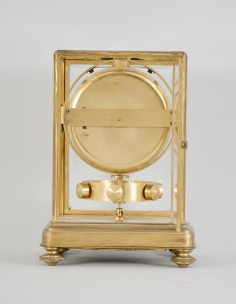 Jean Leon Reutter / Jaeger LeCoultre, an early model K2 shelf or mantel clock, the gilt brass case with molded base on turned feet, and ovolo molded frame set with five bevelled glasses, roman numeral white enamel dial signed "Atmos Pendule Perpetuelle" below 12:00, and " Brevets J. L. Reutter Made in France" below 6:00, blued steel Breguet style hands, 16 jewel, nickel plated LeCoultre cal. 30A movement with lever escapement, gilt, pivoted drum containing a mercury and ammonia filled glass U tube, rocking with changes in temperature and thereby rewinding the mainspring, and large, gilt, torsion pendulum with temperature compensation attachment, movement serial #1176, frame serial #1467