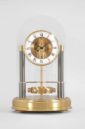 Jaeger-LeCoutre, Switzerland, "Atmos 150th Anniversary" mantel clock, 14 jewel, caliber 540 movement with torsion pendulum in a gilt case and base with glass dome, roman numeral white painted dial, and black painted hands.