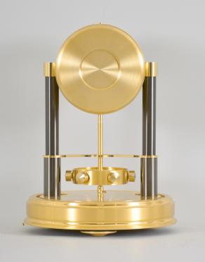 Jaeger-LeCoutre, Switzerland, "Atmos 150th Anniversary" mantel clock, 14 jewel, caliber 540 movement with torsion pendulum in a gilt case and base with glass dome, roman numeral white painted dial, and black painted hands.