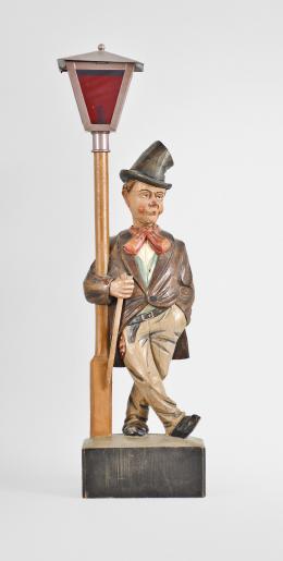 Karl Griesbaum, Triberg, Germany, carved "Hobo" or "Drunkard" whistling figure, spring driven brass movement driving a bellows, cam-controlled slide whistle, and head turn motion enclosed in a hand carved wood figure depicting an inebriated man in a top hat who leans on a lamp post, the top of which contains a battery powered bulb behind red glass.