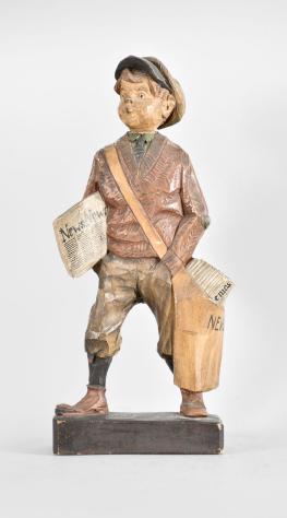 Karl Griesbaum, Triberg, Germany, "Newsboy" whistling figure, spring driven brass movement driving a bellows, cam-controlled slide whistle, and head motion, enclosed in a hand carved wood figure depicting a boy in a flat cap and nickers with a newspaper under one arm and a bag full of papers hanging at his side.