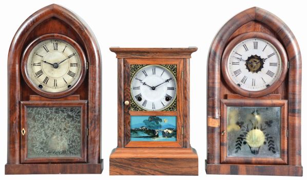 Clocks- 3 (Three): (1) Atkins Clock Co., Bristol, Conn., "Cottage XX" shelf clock with a spring driven, 8 day, time and strike movement in a rosewood veneered case, c1860; (2) Brewster & Ingrahams, Bristol, Conn., "Round Gothic" or "Beehive" shelf clock with a spring (brass) driven, 8 day, time and strike movement in a mahogany veneered case, c1848. (3) William L. Gilbert, Winchester, Conn., "Beehive" shelf clock with a spring driven, 8 day time, strike and alarm movement in a rosewood veneered case, c1850.