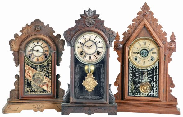 Clocks- 3 (Three): (1) E, Ingraham CLock Co., Bristol, Conn., "Cadet" shelf clock with a spring driven, 8 day time, strike & alarm movement in a walnut case, c1881; (2) Gilbert Clock Co., Winsted, Conn., "Argus" shelf clock with a spring driven, 8 day, time and strike movement (George B. Owen, Winsted, Conn.) in a walnut case, c1885. (3) F. Kroeber Clock Co., 6 Cortlandt Street, New York, "Wasp" shelf clock with a spring driven, 8 day, time and strike movement in a walnut case, c1884.