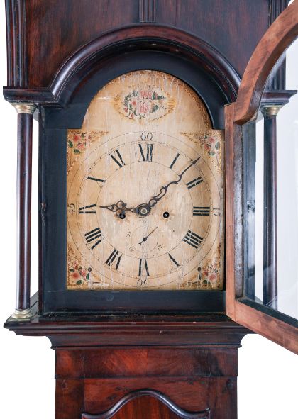 New York stye tall case clock, 8 day, time and bell strike, weight driven movement in a mahogany veneer case with broken arch top, shaped trunk door and scalloped skirt and foot. The painted wooden dial has a seconds bit.