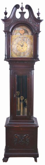Germany, tall clock, 8 day, time, strike and chime on gongs, three brass weight driven movement in a mahogany case with beveled glass trunk door, broken arch top, paw feet, three wooden finials and applied moldings on base with brass dial, silvered chapter ring, applied brass spandrels, moon phase and seconds bit.