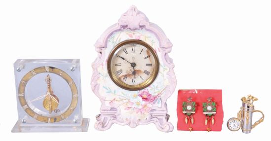 Clocks- 3 (Three): (1) Ansonia Clock Co., New York, miniature porcelain clock, 30 hour, time only in lavender outlined case with floral motif; (2) Switzerland, LeCoultre, desk clock with 16 jewel balance wheel movement in a clear acrylic case. (3) Boardman & Wells, Bristol, Conn., 30 hour, time and strike, weight wood movement half column & splat shelf clock. Lot also comes with a small desk clock in with a golf motif as well as two lapel pins in the shape of cuckoo clocks.