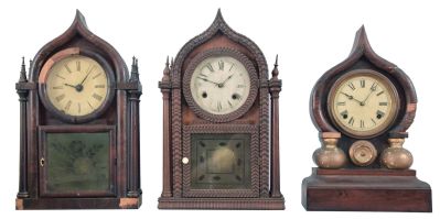 Clocks- 3 (Three): (1) Brewster & Ingrahams, Bristol, Conn., "Round Gothic" shelf clock now fitted with a Seth Thomas spring driven, 8 day, time and strike movement in a mahogany veneered case, c1848; (2) Forestville Mfg. Co., Forestville, Conn., "Round Gothic" shelf clock now fitted with a Waterbury Clock Co. 8 day spring driven time and strike movement in a ripple front rosewood case, c1850. (3) E. Ingraham & Co.,Bristol, Conn., "Oriental" shelf clock with a spring driven, 8 day, time and strike movement in a rosewood veneered case, c1880.