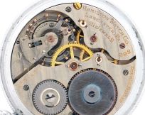 Hamilton Watch Co., Lancaster, Penn., "992E" with unusual regulation and balance spring, 16 size, 21 jewels, stem wind and lever set, adjusted, damascened nickel plate movement with lever escapement, uncut, monometallic balance with gold timing screws, and balance spring with straight overcoil, studded at the back of the balance cock, and with linear regulator in a nickel, screw back and bezel open face case, luminous Arabic numeral and arrow marker black metal dial, skeletonized luminous hands, serial #2587492, c1930.