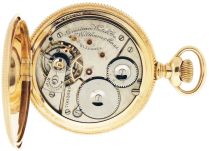 American Waltham Watch Co.,Waltham, Mass., "American Watch Co." model 1888, 16 size, 21 jewels, stem wind and set, adjusted, ornately damascened nickel plate movement with lever escapement, cut bimetallic balance, gold jewel settings, gold timing screws, gold wheel train and Fogg tadpole micrometric regulator in a rose gold filled, engine turned hunting case, and Arabic numeral, outer red 5-minute markers, single sunk "A.W.W.Co." white enamel dial, blued steel spade hands, serial #7003029, c1900.