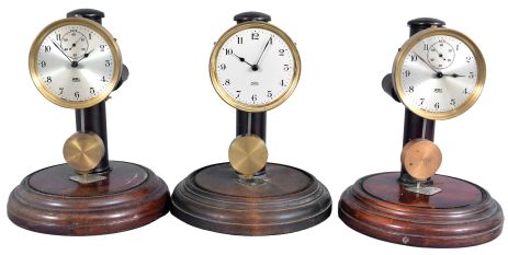 Clocks- 3 (Three) Poole: Poole Mfg. Co., Ithaca, NY, "Executive", electro-mechanical battery-driven mantel timepieces serial numbers1343, 2426, 3676. All with wood bases, two with silvered dials and one with white enamel dial.