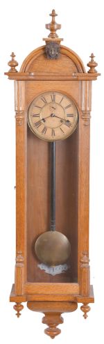 Ansonia Clock Co., New York, "Capitol" model wall timepiece, 8- day double spring movement with seconds bit below 12, in an oak case.
