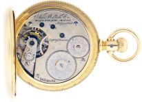 American Waltham Watch Co.,Waltham, Mass., "Am. Watch Co." model 1872, 16 size, 15 jewels, stem wind and lever set, adjusted, damascened, nickel plate movement with lever escapement, gold timing screws and Fogg tadpole micrometric regulator in an 18 karat, yellow gold, reeded edge, engine turned and engraved hunting case and Roman numeral, outer red 5-minute markers, single sunk white enamel dial, blued steel Breguet style hands, serial #2634852, 130.6g TW, c1885.