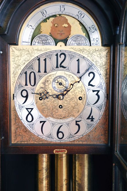 The Colonial Mfr. Co., Zeeland, Mich., tall case clock, 8 day, time, strike and five tubular chime, three brass weight driven movement in a mahogany case with a brass dial with silvered chapter ring, seconds bit and moon phase