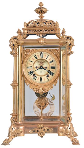 Ansonia Clock Co., New York, "Excelsior" crystal regulator, 8 day, time and strike, spring driven movement with visible Brocot escapement in a gilt finished brass case on claw feet, cream porcelain dial with Roman numerals and red interstitial decorations, cast pendulum with female face, strikes on cathedral gong.