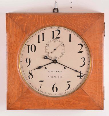 Clocks- 2 (Two) American wall clocks: (1) Seth Thomas Clock Co., Thomaston, Conn., 30 day, time only, double spring driven gallery clock in square oak case; (2) New Haven Clock Co., New Haven, Conn., "Washington Chime", 8 day, time, strike and Westminster chime banjo in a mahogany case