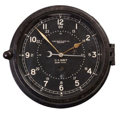 Chelsea Clock Co., Boston, Mass., "11E Deck & Engine Room" timepiece, 8 day, time only, spring driven, jeweled movement with gold hands, center seconds, in a black phenolic case with 8.5 inch black dial with 12/24 numerals, dial reading "U.S. NAVY, SER. NO. 49902E ".