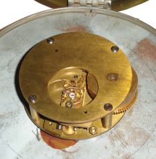 Chelsea Clock Co., Boston, Mass., "11E Deck & Engine Room" clock, 8 day, time only, spring-driven with jeweled movement, center seconds in a brass case with 8.5 inch dial showing 12/24 numerals, signed by Chelsea and "U.S. GOVERNMENT", all mounted to a mahogany backing board.