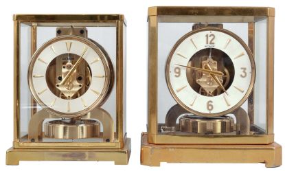 Clocks- 2 (Two) Atmos: (1) Jaeger-LeCoultre, Switzerland, "Atmos" clock, 15 jewel, caliber 526-5 movement, torsion pendulum, round metal dial with applied gilt arrow markers, gilt hands, all contained in a rectangular case with original cloth covered box, serial #83408, c1955; (2) Jaeger-LeCoultre, Switzerland, "Atmos" clock, 15 jewel movement, torsion pendulum, round metal dial with applied gilt numerals, arrow markers, and hands.