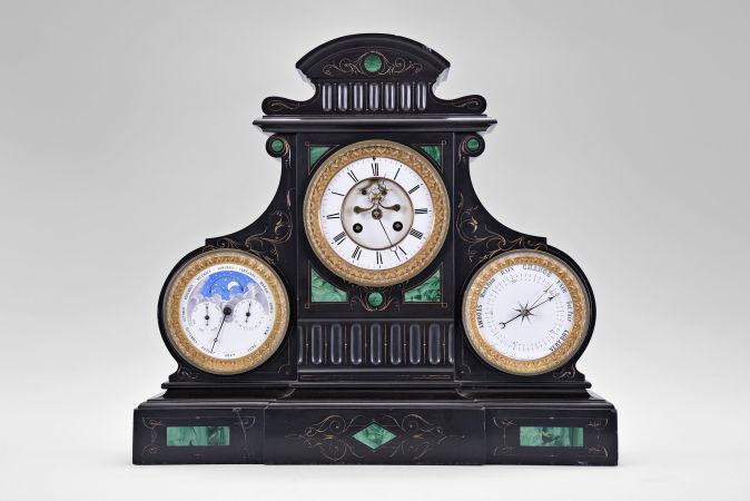 France, monumental mantel clock, 8 day, time and strike, spring driven movement with triple calendar, moon phases and barometer in a black slate case with green malachite insets and incised gold highlights. All dials are white enamel and the clock has exposed Brocot escapement on center dial.