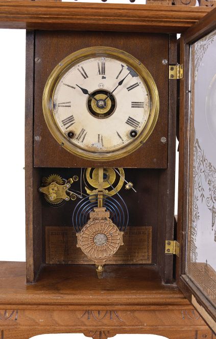 Seth Thomas Clock Co., Thomaston, Conn., "Eclipse", 8 day, time, strike and alarm spring brass movement walnut case mantel clock.