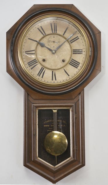 Ansonia Clock Co., New York, "Regulator A" wall clock, 8 day, time and strike, spring driven movement in a walnut case with paper dial with subsidiary seconds and blued steel hands.