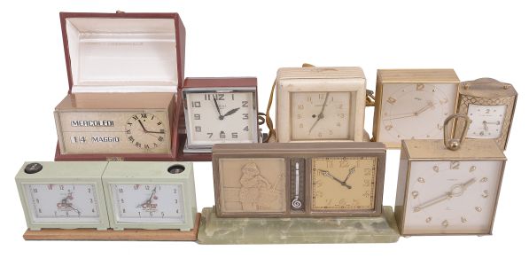 Clocks- 8 (Eight): Lot includes five mechanical and electric double-sided desk clocks by makers such as Phinney-Walker, Semca, Imhof, and Twinface; an English chess clock by Sutton Coldfield; a Swiss-made electric desk calendar clock displaying Italian language; a Swiss double-sided clock with calendar and thermometer on a green marble base.