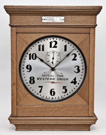 Self Winding Clock Company, New York, "No. 10-A Self Winding Clock", spring driven movement with deadbeat escapement and battery wind mechanism in an oak case with 14 inch aluminum dial reading "Official Time / Western Union ".