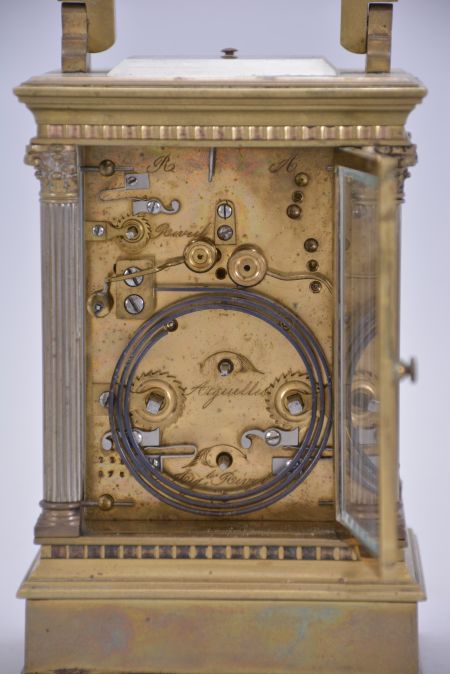 France, carriage clock, 8 day, time and strike with alarm and hour repeat, spring driven movement with lever platform escapement in an Anglaise case with stepped, molded base and cornice, the corners with Corinthian columns, and the top with carrying handle, Roman numeral white enamel dial, and blued steel distaff hands.