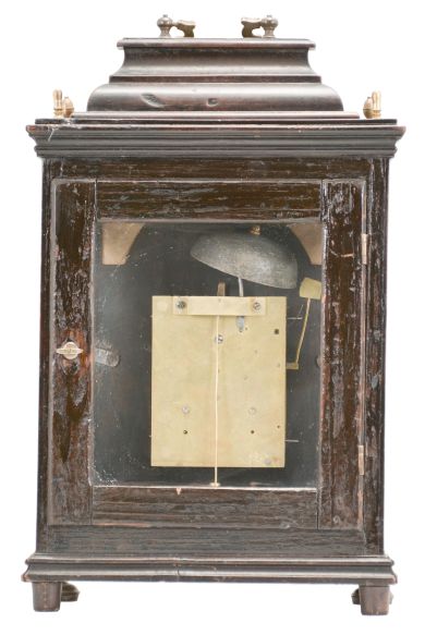 Austria, a late 18th century, repeating bracket clock with mock pendulum, ebonized hardwood case on compressed, silvered ball feet, plain rectangular door allowing a veiw of the decorative dial, molded top with brass finials and caddy top with brass handle, case sides with tombstone arch windows, and back also with rectangular, glazed door, silvered repousse dial with C scrolls, flowers, and bowknot with laurel festoon, the upper corners pierced, and with green paper backing, brass roman numeral chapter ring with arabic five minute markers, blued steel beetle and poker hands, 30- 60 hour brass movement with crown wheel escapement, rack striking, and repeating the last hour on demand