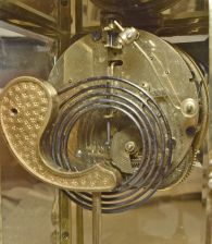 Ansonia Clock Co., New York, "Marchioness" crystal regulator with a spring driven 8 day time and half hour strike (rack and snail) movement (visible escapement) in a polished brass case with rich gold ornaments.