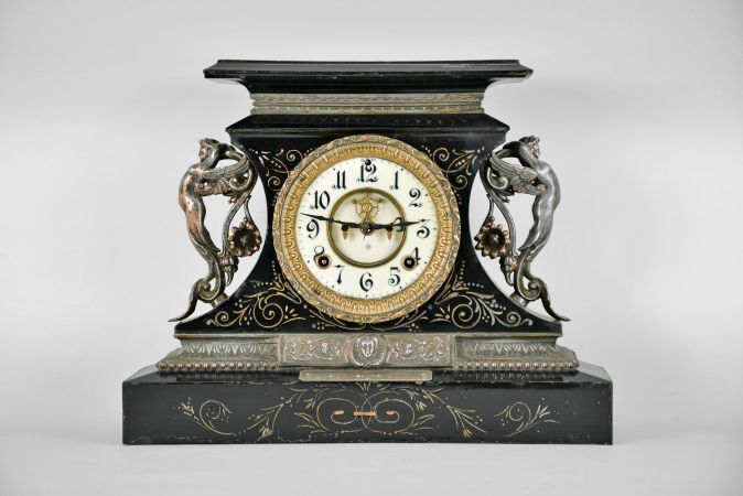 Ansonia Clock Co., New York, "Rosalind" 8 day, time and spring brass movement cast iron black mantel clock with visible escapement. A plaque on the case reads: "Presented by Mr. & Mrs. B. Uberwasser", Sept. 15th, 1906 ".