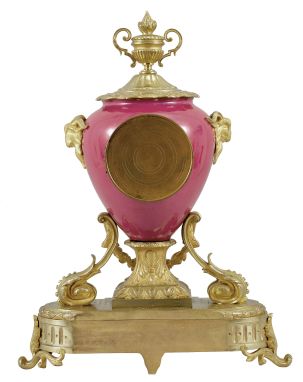 France, ceramic and ormolu mantel clock, 8 day, time and strike, spring driven pendule de Paris movement in a vibrant porcelain vase-form case mounted on a gilt metal base with floral swag, flanked by horned rams, and topped with an urn finial, polychrome painted dial with putto, gilt hands.