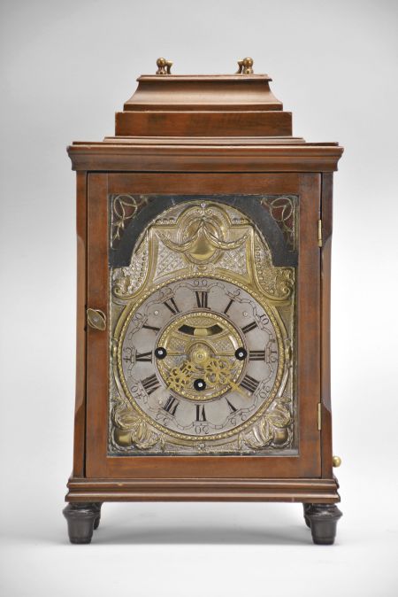 Austria, bracket clock, 30 hour, time and Viennese grand sonnerie strike, three train spring driven movement with verge escapement in hardwood case on ebonized turned feet, molded base and cornice, stop-chamfered front corners, glazed sizes, and stepped top with carrying handle, partially silvered brass dial surround with applied arcaded silvered chapter ring showing Roman numerals, aperture with faux pendulum, and pierced gilt hands.