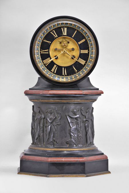 E. Maurice & Co., Paris, France, for Shreve, Crump & Low, Boston, mantel clock, 8 day, time and strike, spring driven pendule de Paris movement with visible Brocot escapement on an molded octagonal base with gilt brass and red marble ovolo molding supporting a central column with the Greek muses cast with relief from patinated metal, supporting a molded octagonal capital upon which rests a drum head of black slate holding the movement, bezel, and polished black slate dial with incised Roman numerals and gilt hands.