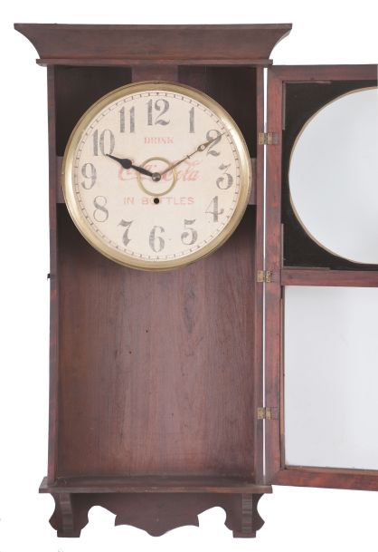 William L. Gilbert Clock Co., Winsted, Conn., "University" wall hanging store regulator with a spring driven 8 day timepiece movement with a 12" Coca Cola advertising dial in a wooden case with a polished mahogany finish.