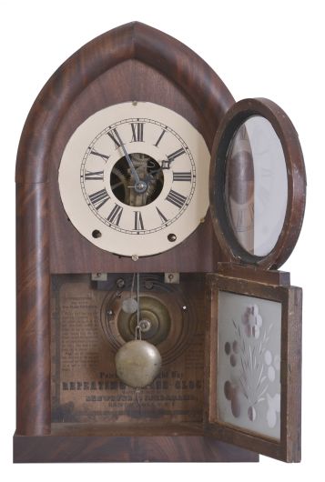 Brewster & Ingrahams, Bristol, Conn., 8 day, time and strike spring brass movement round gothic or beehive shelf clock with rack and snail strike and case iron spring barrels.