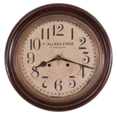 Clocks- 2 (Two): (1) Ansonia Clock Co., New York, "Gresham" wall hanging gallery clock with a 12 inch dial, dial reading "P. Allana & Bros / Karachi." and a spring driven 8 day time and strike movement in a finished mahogany case. c1894. (2) Seth Thomas Clock Co., Thomaston, Conn., "Office No. 5" wall hanging clock with a spring driven 8 day time and strike movement in an oak case. c1904.