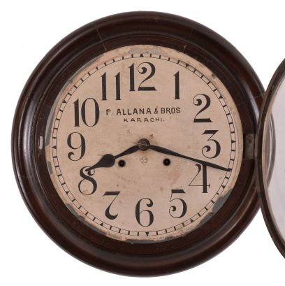 Clocks- 2 (Two): (1) Ansonia Clock Co., New York, "Gresham" wall hanging gallery clock with a 12 inch dial, dial reading "P. Allana & Bros / Karachi." and a spring driven 8 day time and strike movement in a finished mahogany case. c1894. (2) Seth Thomas Clock Co., Thomaston, Conn., "Office No. 5" wall hanging clock with a spring driven 8 day time and strike movement in an oak case. c1904.