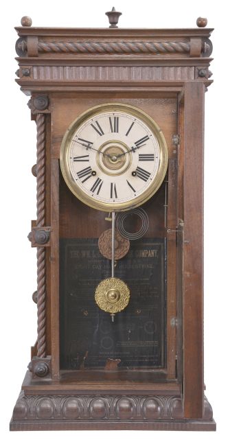 Anglo- American, Vienna style, 8 day, time and strike spring brass movement wall clock with an American movement.