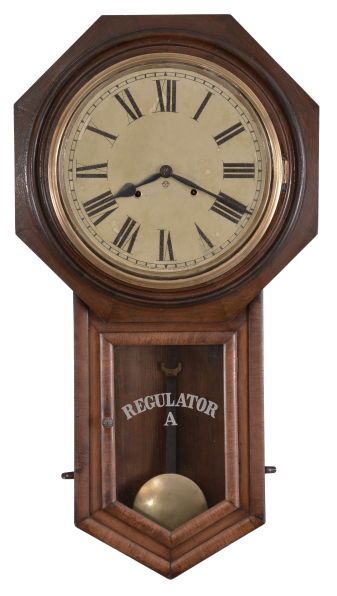 Clocks- 2 (Two): (1) Ansonia Clock Co., New York, "Regulator A" wall clock with a spring driven 8 day time and half hour strike in a black walnut case. c1895. (2) Ansonia Clock Co., New York, "Office Regulator" wall clock with a spring driven 8 day time and half hour strike with seconds bit in a black walnut case. c1895.