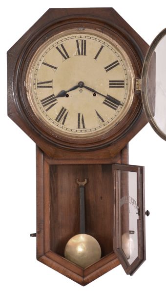 Clocks- 2 (Two): (1) Ansonia Clock Co., New York, "Regulator A" wall clock with a spring driven 8 day time and half hour strike in a black walnut case. c1895. (2) Ansonia Clock Co., New York, "Office Regulator" wall clock with a spring driven 8 day time and half hour strike with seconds bit in a black walnut case. c1895.