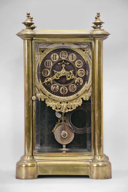 Ansonia Clock Co., New York, "Symbol Extra", 8 day, time and strike spring brass movement crystal regulator shelf clock with black and gilt hard rubber dial.