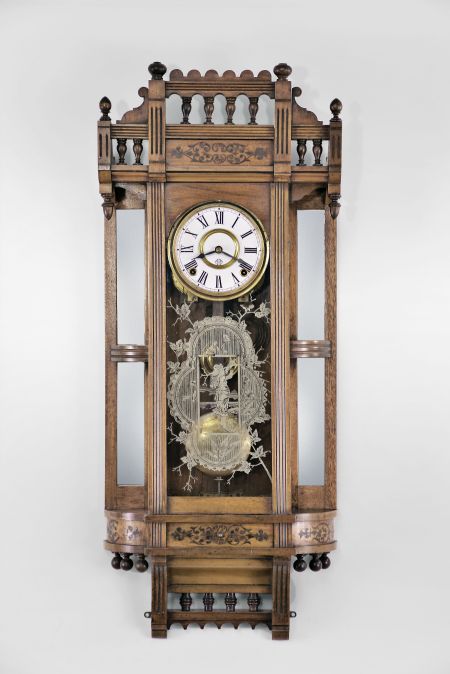 Ansonia Clock Co., New York, "Reflector" wall hanging clock with a spring driven 8 day time and strike (cathedral gong) movement in a walnut case.